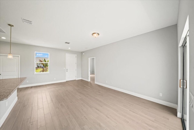 unfurnished living room with recessed lighting, baseboards, visible vents, and light wood-type flooring