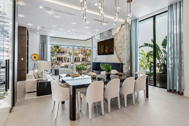 207 W Coconut Palm Rd, Boca Raton, FL 33432 - dining room with recessed lighting, a premium fireplace, and floor to ceiling windows