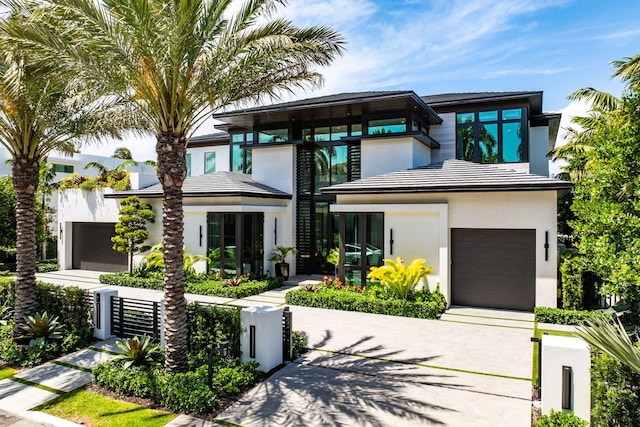 207 W Coconut Palm Rd, Boca Raton, FL 33432 - view of front of property featuring fence, stucco siding, driveway, and an attached garage