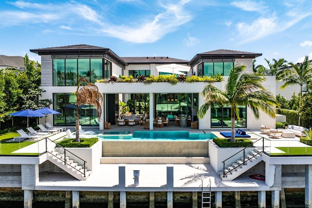 207 W Coconut Palm Rd, Boca Raton, FL 33432 - back of house with stairway, an infinity pool, and a patio area