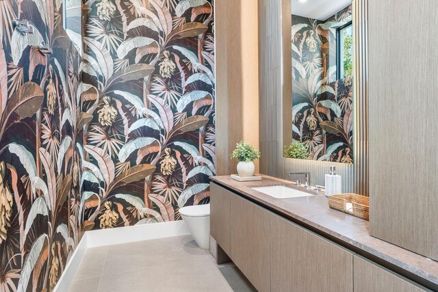 207 W Coconut Palm Rd, Boca Raton, FL 33432 - bathroom featuring tile patterned floors, wallpapered walls, toilet, and vanity