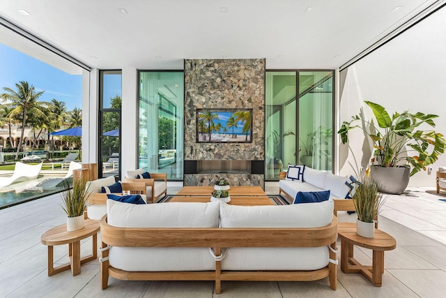 207 W Coconut Palm Rd, Boca Raton, FL 33432 - living room with tile patterned floors, a fireplace, and floor to ceiling windows
