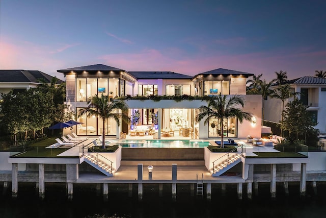 207 W Coconut Palm Rd, Boca Raton, FL 33432 - rear view of property with a patio and an infinity pool
