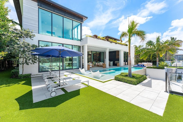 207 W Coconut Palm Rd, Boca Raton, FL 33432 - back of house with a yard, a patio, an outdoor pool, and a balcony