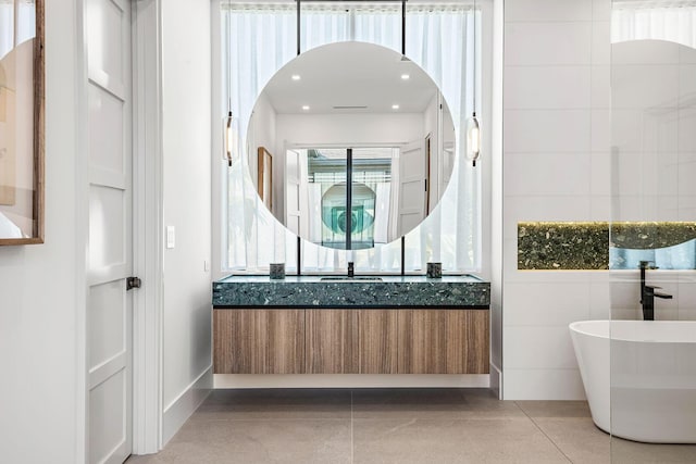 207 W Coconut Palm Rd, Boca Raton, FL 33432 - full bathroom with vanity, a freestanding bath, and tile patterned flooring