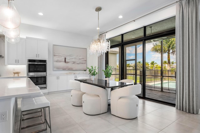 dining space with light tile patterned floors, a chandelier, and recessed lighting
