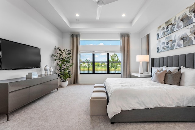 bedroom featuring carpet flooring, a raised ceiling, and recessed lighting