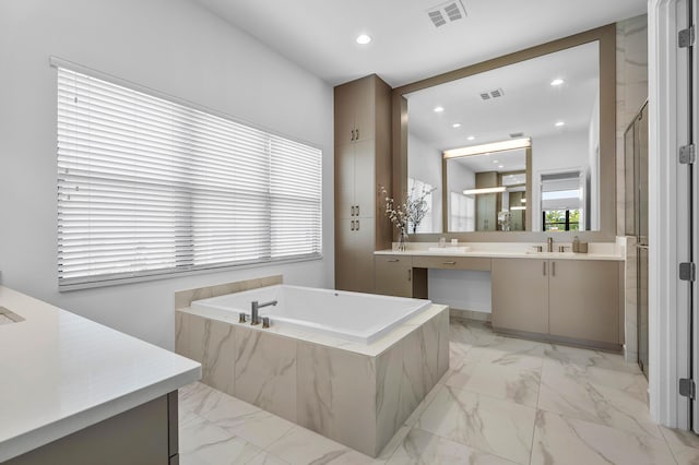 bathroom with marble look tile flooring, a stall shower, vanity, a garden tub, and recessed lighting