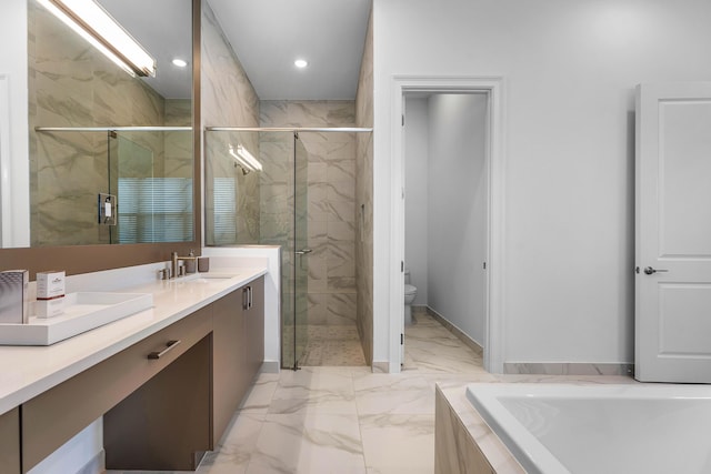 bathroom featuring a marble finish shower, toilet, double vanity, marble finish floors, and a tub