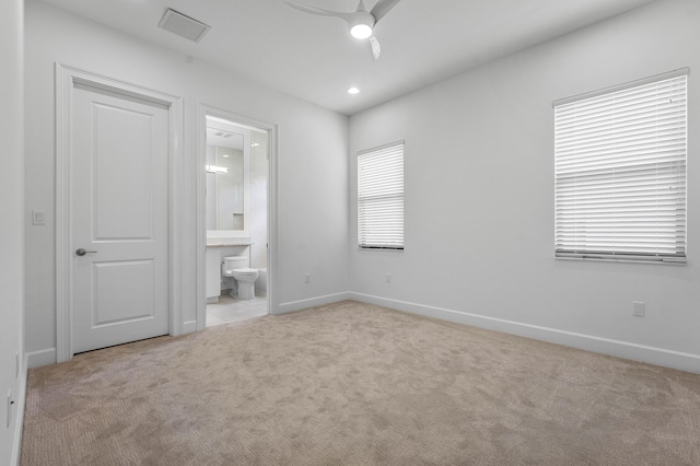 unfurnished bedroom with carpet floors, ensuite bath, baseboards, recessed lighting, and ceiling fan