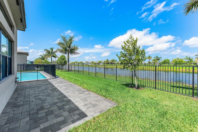 view of yard with a water view and a patio