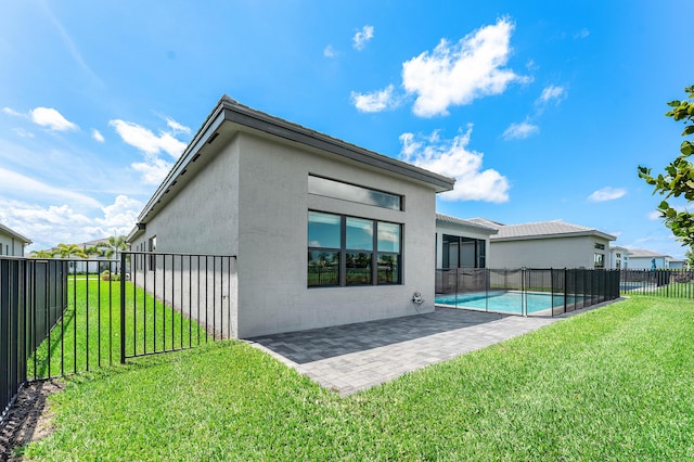 back of house featuring stucco siding and a patio