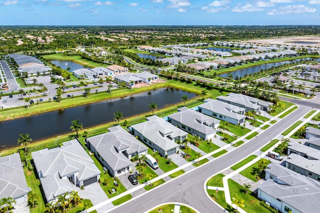 aerial view of residential area featuring a large body of water