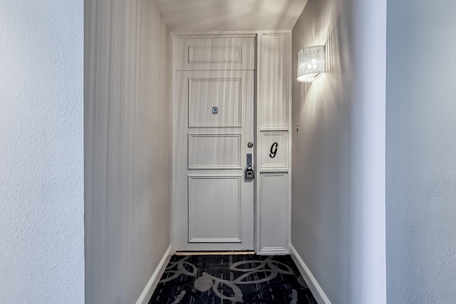 doorway featuring baseboards