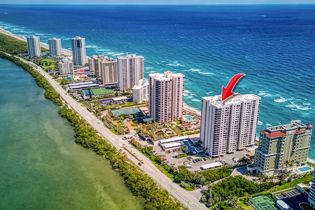 aerial view featuring a city view and a water view