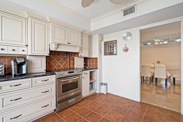 kitchen with crown molding, decorative backsplash, stainless steel range with electric cooktop, under cabinet range hood, and visible vents