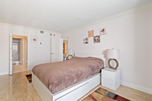 bedroom with baseboards, ornamental molding, a textured ceiling, and visible vents