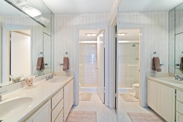 full bath with tile patterned floors, a textured ceiling, a stall shower, toilet, and vanity