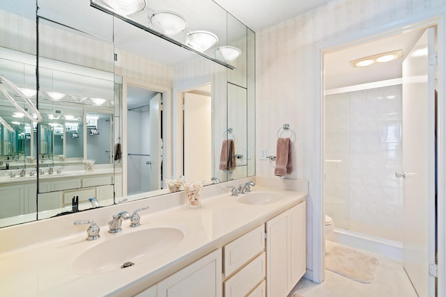 full bath with tile patterned flooring, a sink, double vanity, and a stall shower