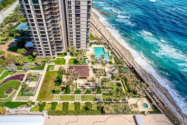 birds eye view of property featuring a beach view and a water view