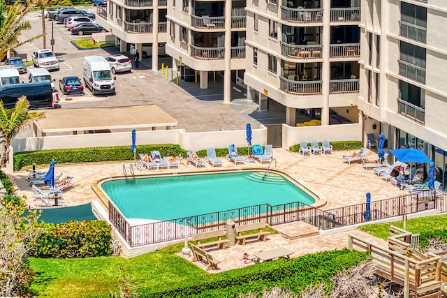community pool featuring a patio area and fence