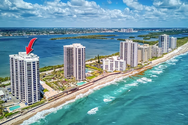 birds eye view of property with a view of city, a view of the beach, and a water view