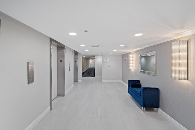 hallway featuring recessed lighting, elevator, visible vents, and baseboards