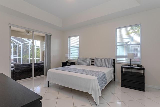 541 NW Pine Sap Pl, Jensen Beach, FL 34957 - bedroom with access to outside, light tile patterned floors, and baseboards