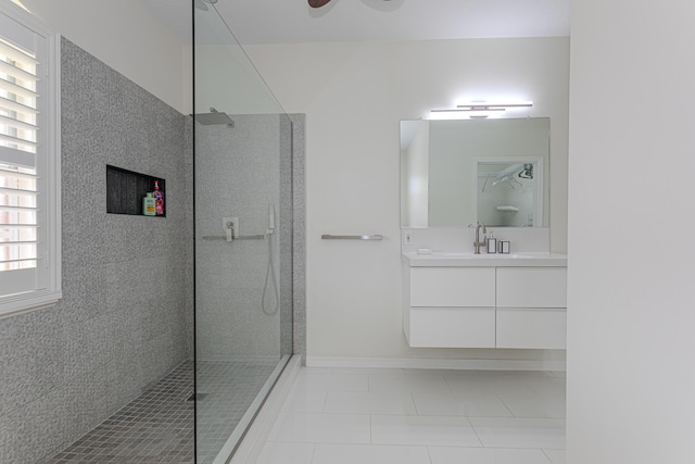 541 NW Pine Sap Pl, Jensen Beach, FL 34957 - full bathroom with tile patterned flooring, vanity, walk in shower, and baseboards