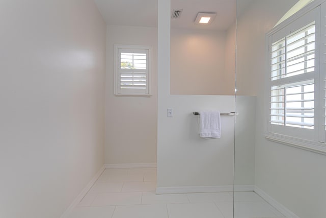 541 NW Pine Sap Pl, Jensen Beach, FL 34957 - bathroom featuring baseboards and tile patterned flooring