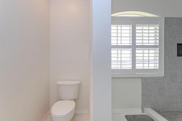 541 NW Pine Sap Pl, Jensen Beach, FL 34957 - bathroom featuring toilet, tile patterned floors, and baseboards