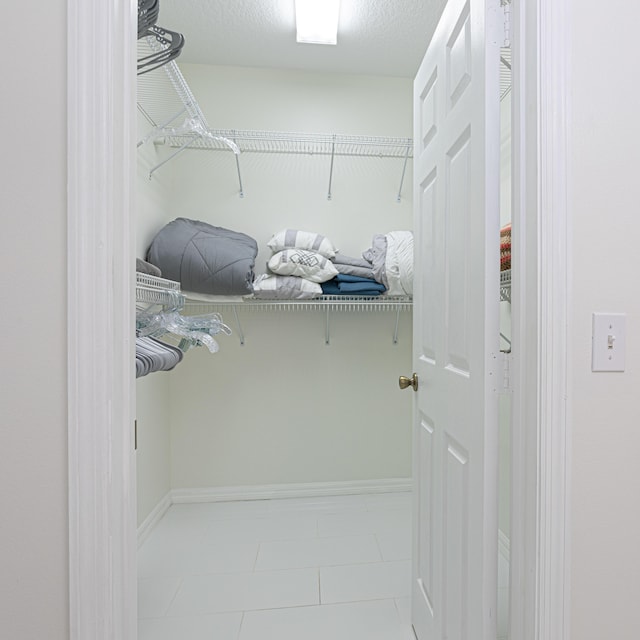 541 NW Pine Sap Pl, Jensen Beach, FL 34957 - walk in closet with tile patterned floors