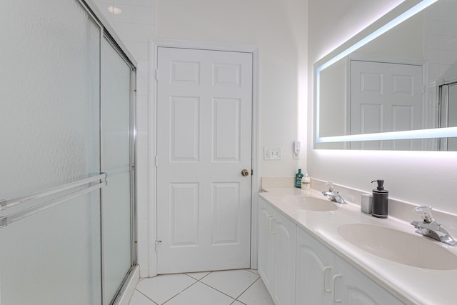 541 NW Pine Sap Pl, Jensen Beach, FL 34957 - bathroom featuring a shower stall, tile patterned floors, and double vanity