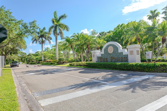 541 NW Pine Sap Pl, Jensen Beach, FL 34957 - view of asphalt road featuring curbs and view of wooded area