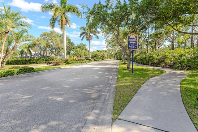 541 NW Pine Sap Pl, Jensen Beach, FL 34957 - view of asphalt road featuring curbs and sidewalks