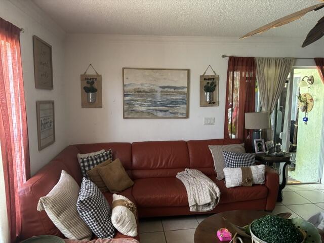 6207 Adriatic Way, West Palm Beach, FL 33413 - tiled living room featuring a textured ceiling