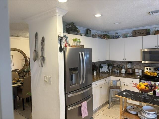 6207 Adriatic Way, West Palm Beach, FL 33413 - kitchen with dark countertops, tasteful backsplash, light tile patterned flooring, stainless steel appliances, and visible vents