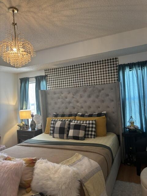 6207 Adriatic Way, West Palm Beach, FL 33413 - bedroom featuring wood finished floors and a textured ceiling