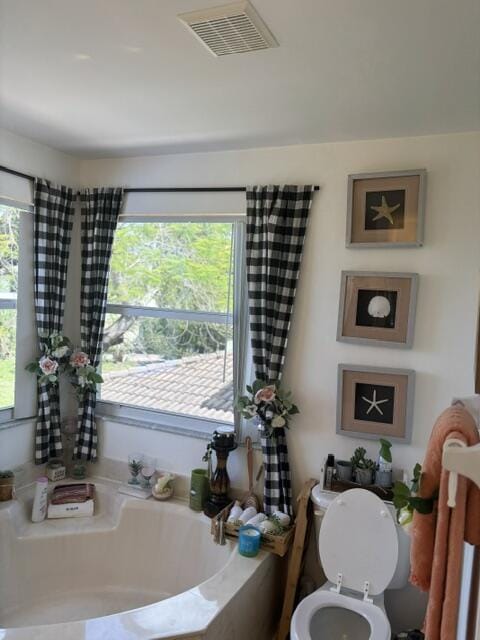 6207 Adriatic Way, West Palm Beach, FL 33413 - bathroom with a bath, toilet, a healthy amount of sunlight, and visible vents