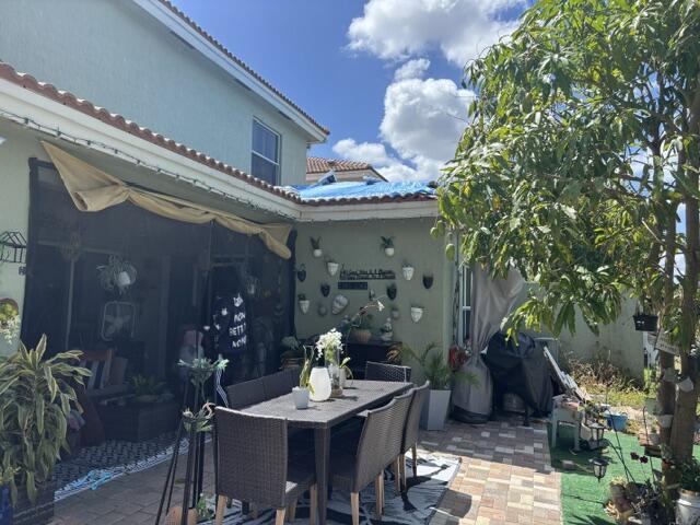 6207 Adriatic Way, West Palm Beach, FL 33413 - view of patio with outdoor dining area and area for grilling