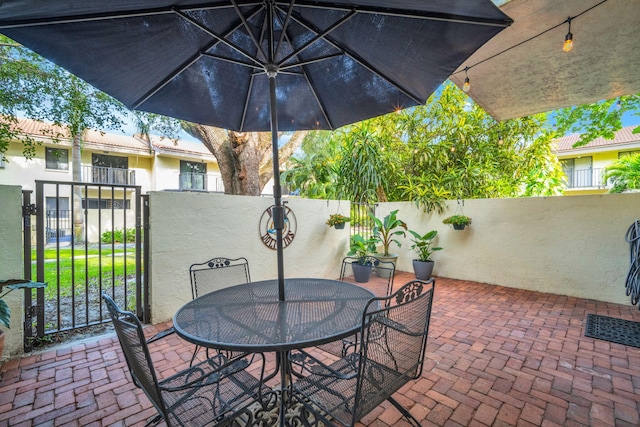 view of patio featuring fence and outdoor dining space