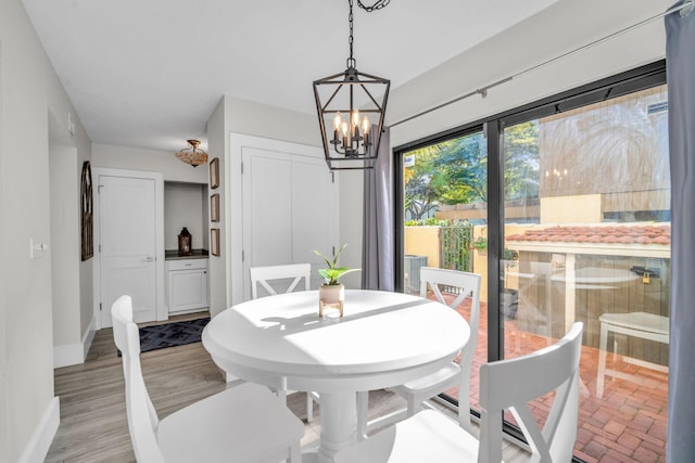 dining room with baseboards and a notable chandelier