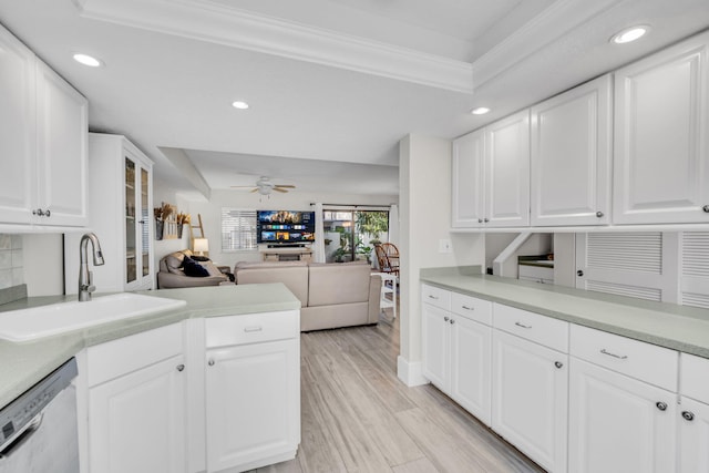 kitchen featuring stainless steel dishwasher, recessed lighting, open floor plan, and a sink