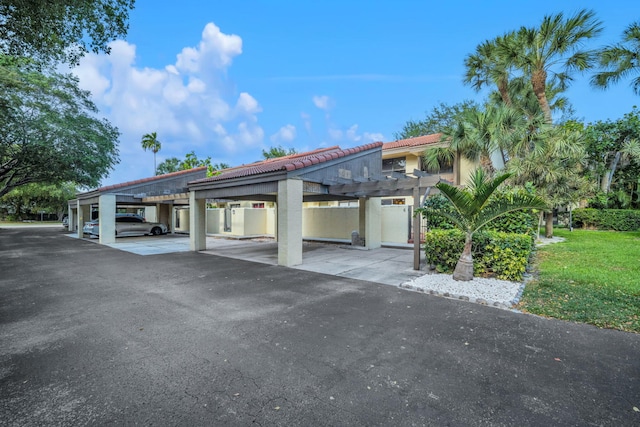1330 NW 13th St Unit 6, Boca Raton, FL 33486 - view of front facade with a tiled roof, covered parking, and stucco siding