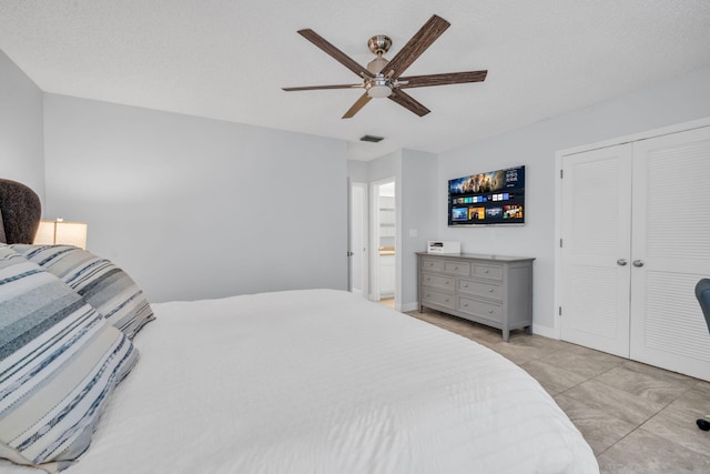 bedroom with baseboards, ceiling fan, a closet, and visible vents