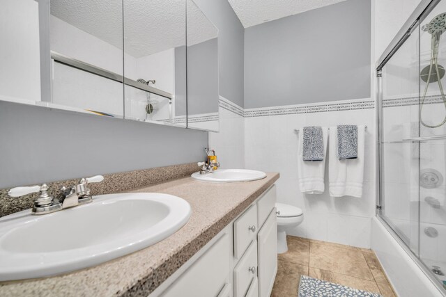 bathroom with a sink, toilet, and a textured ceiling