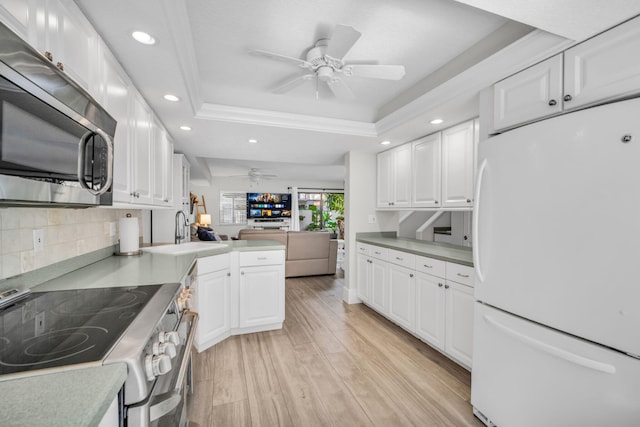 1330 NW 13th St Unit 6, Boca Raton, FL 33486 - kitchen featuring appliances with stainless steel finishes, a tray ceiling, ceiling fan, a sink, and open floor plan