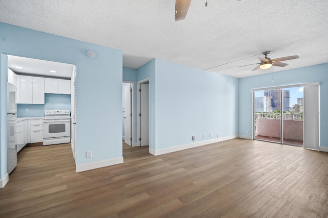 unfurnished living room with wood finished floors, a textured ceiling, and a ceiling fan