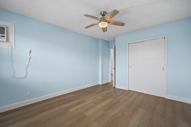unfurnished bedroom with baseboards, wood finished floors, and a closet