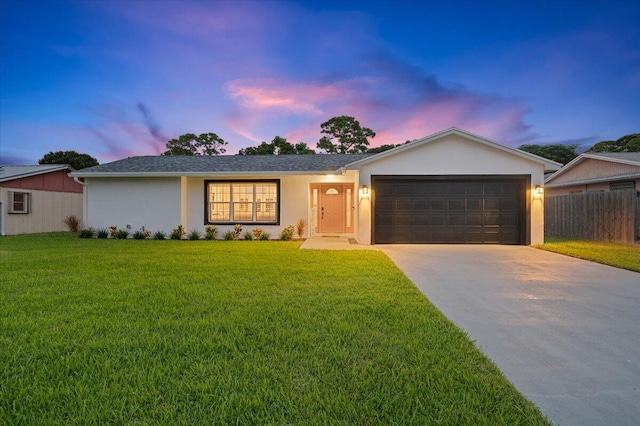 509 Oak Ter, Jupiter, FL 33458 - ranch-style home featuring concrete driveway, an attached garage, fence, a yard, and stucco siding